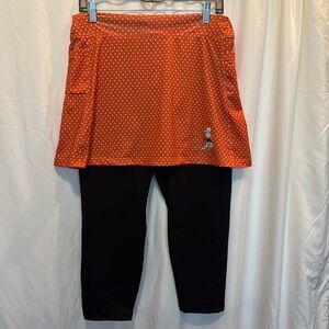 Running skirt.  Orange & white polka dots with attached black leggings.